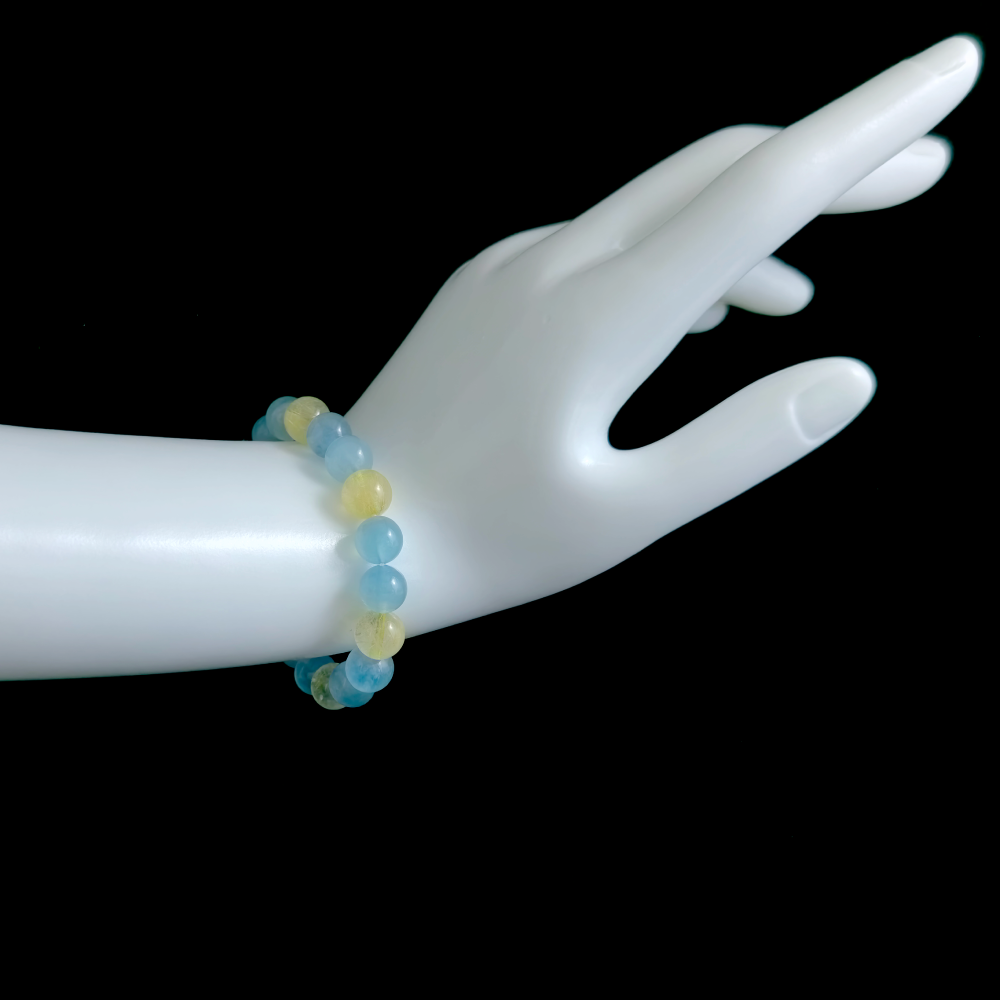 Aquamarine and Golden Rutilated Quartz bracelet worn on hand showing confident speaking and clear presence