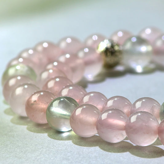 Close-up of Rose Quartz and Prehnite beads in a crystal bracelet for emotional openness and social expansion
