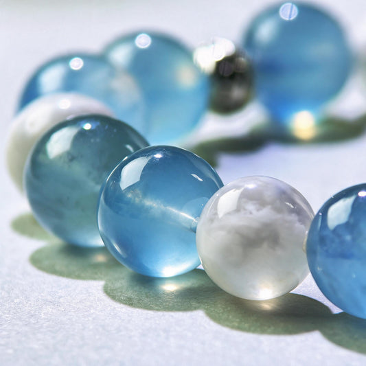 Close-up of Aquamarine and White Phantom Quartz beads in a crystal bracelet for smoother expression and easier communication