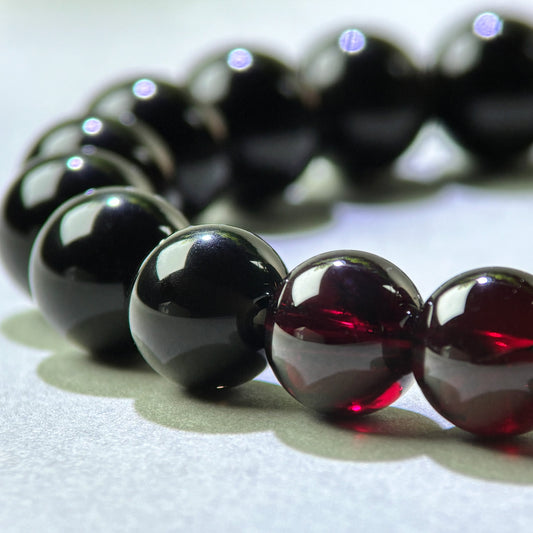 Close-up of Garnet and Black Tourmaline beads in a crystal bracelet for gently easing emotional numbness