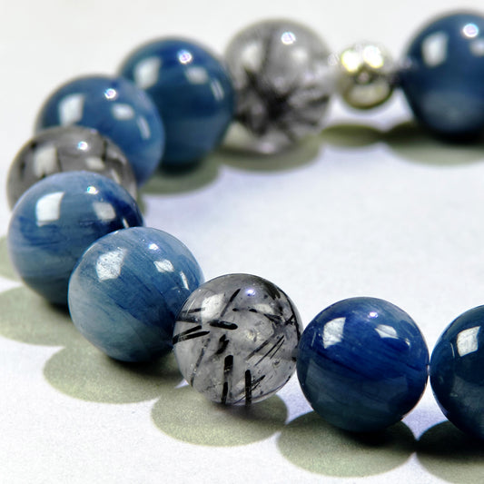 Close-up of Blue Kyanite and Black Rutilated Quartz beads for expression and filtering outside pressure