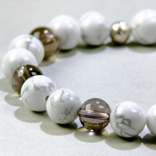 Close-up of Howlite and Smoky Quartz beads in a crystal bracelet for patience, calm, and grounding