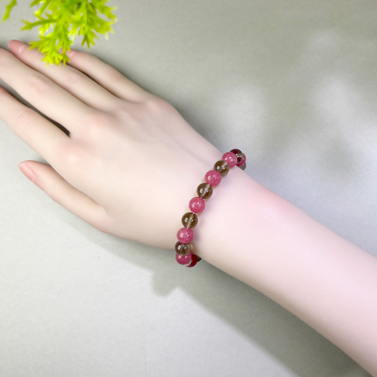 Rhodonite and Smoky Quartz bracelet worn on wrist for staying grounded while working through past emotional hurt