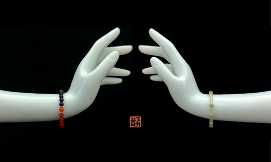 Two mannequin hands wearing crystal bracelets on left and right wrists, symbolizing how crystal energy differs based on which hand you wear it – wearable Feng Shui guide.
