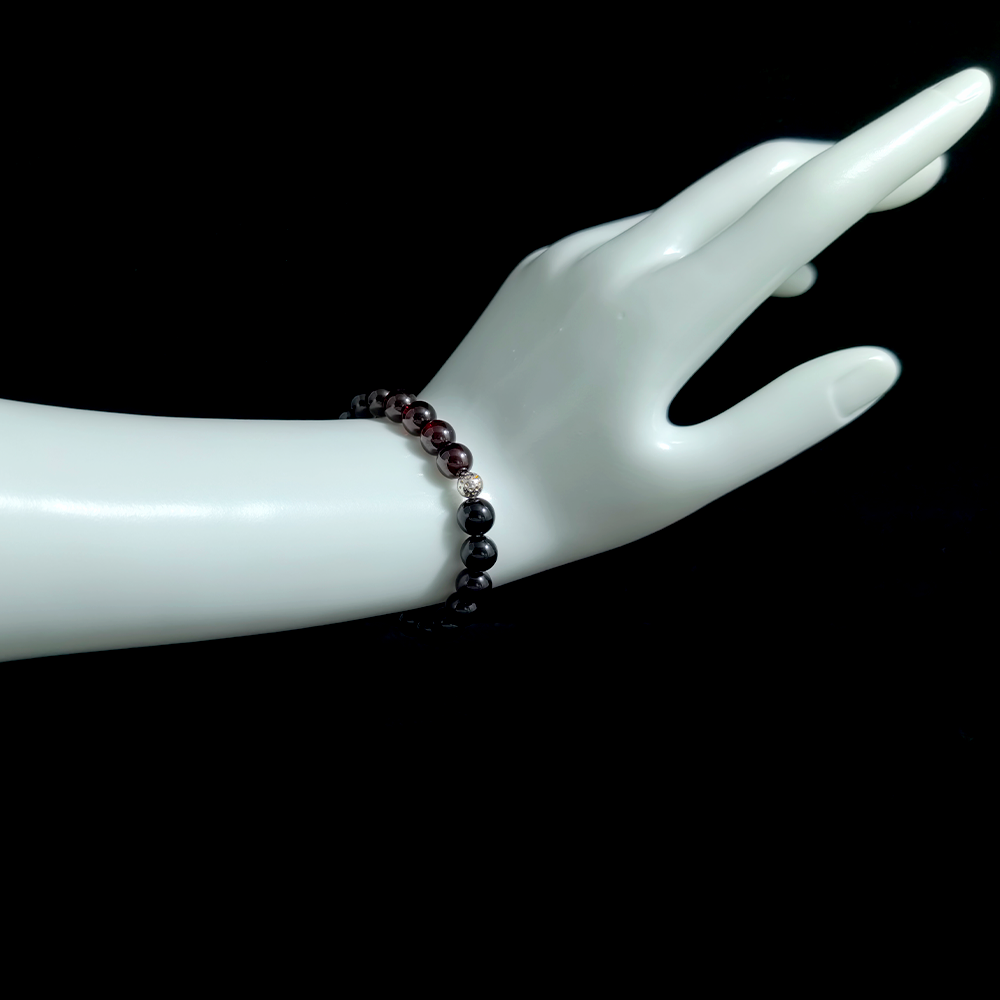 Garnet and Black Tourmaline bracelet worn on hand for easing emotional numbness, restoring warmth, and supporting slow emotional recovery – JING Balance