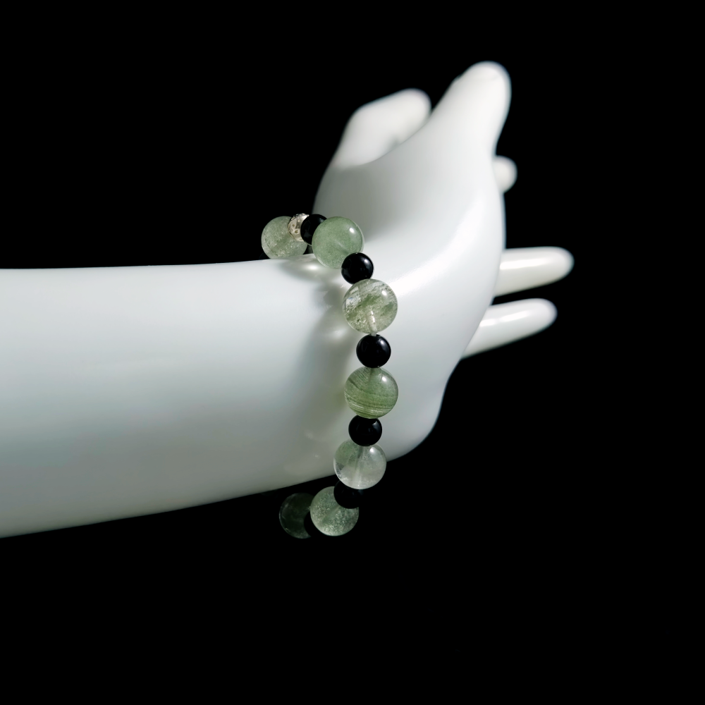 Green Phantom Quartz and Obsidian bracelet worn on hand showing focused progress and stable momentum under pressure