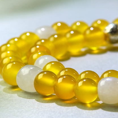 Close-up of Yellow Agate and White Hetian Jade beads in a crystal bracelet for a clearer sense of completion and internal stability