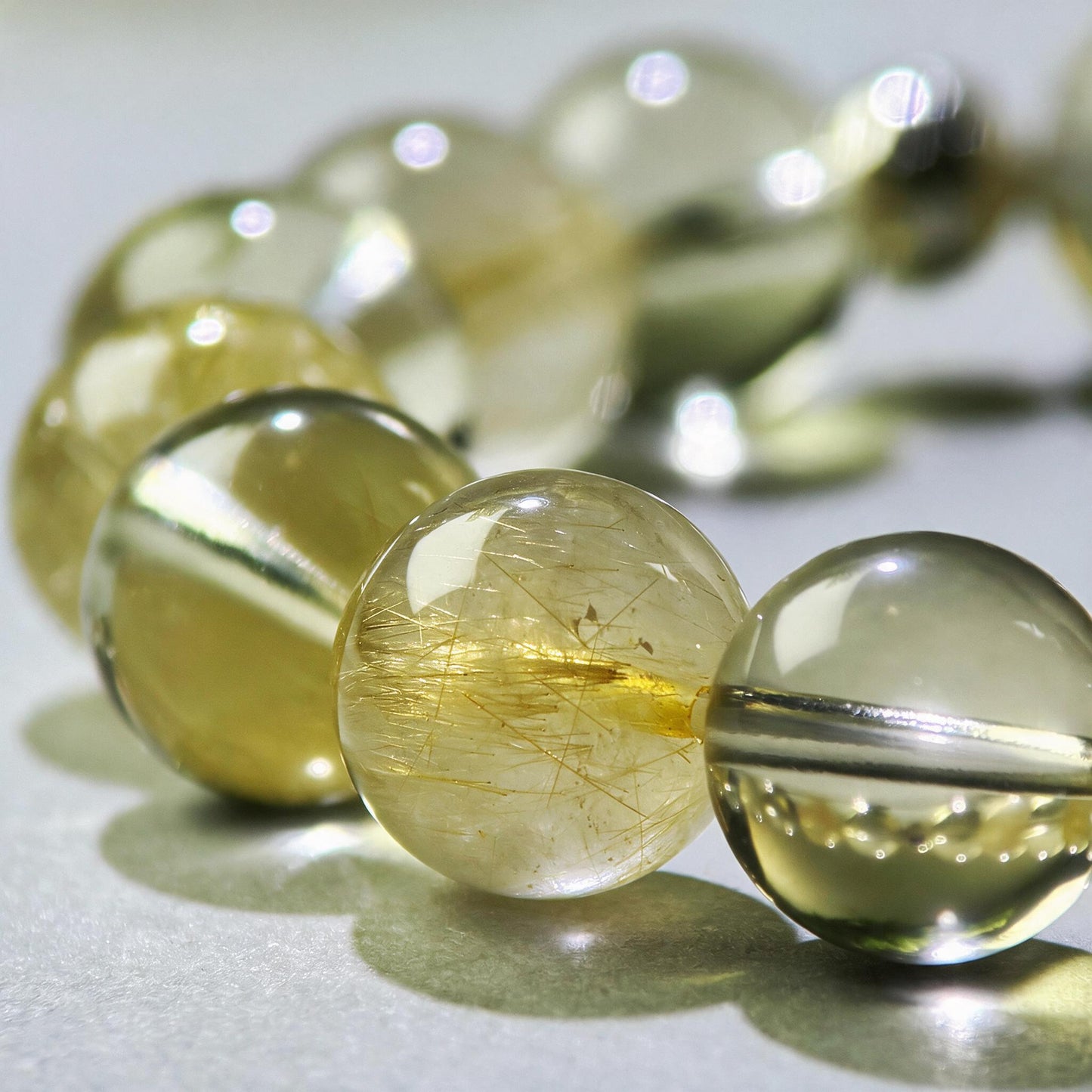 Close-up of Golden Rutilated Quartz and Citrine beads in a crystal bracelet for holding your results