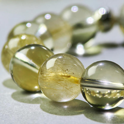 Close-up of Golden Rutilated Quartz and Citrine beads in a crystal bracelet for holding your results