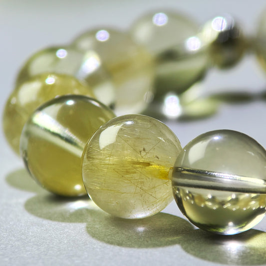 Close-up of Golden Rutilated Quartz and Citrine beads in a crystal bracelet for holding your results
