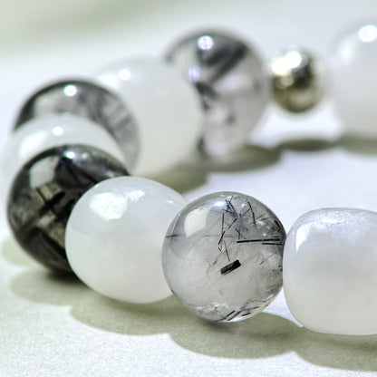 Close-up of White Hetian Jade and Black Rutilated Quartz beads in a crystal bracelet for clearer emotional boundaries
