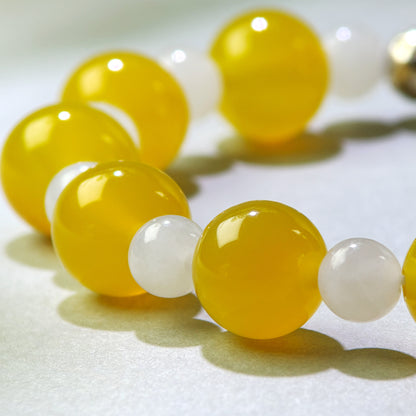 Close-up of Yellow Agate and White Hetian Jade beads in a crystal bracelet for replaying past relationship memories