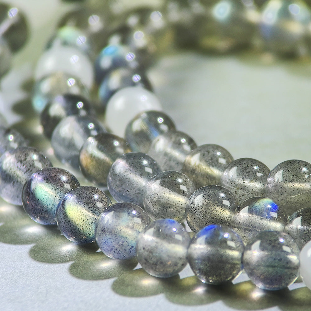 Close-up of Gray Moonstone and White Hetian Jade beads in a crystal bracelet for emotional calming and inner stability
