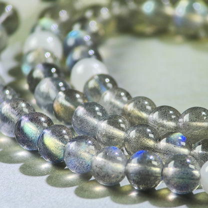 Close-up of Gray Moonstone and White Hetian Jade beads in a crystal bracelet for emotional calming and inner stability