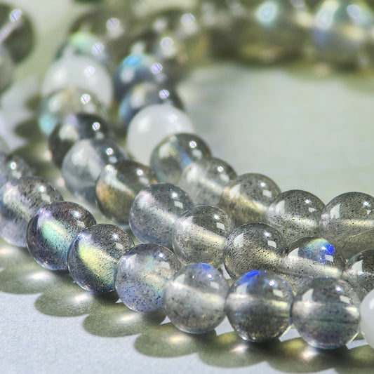 Close-up of Gray Moonstone and White Hetian Jade beads in a crystal bracelet for emotional calming and inner stability