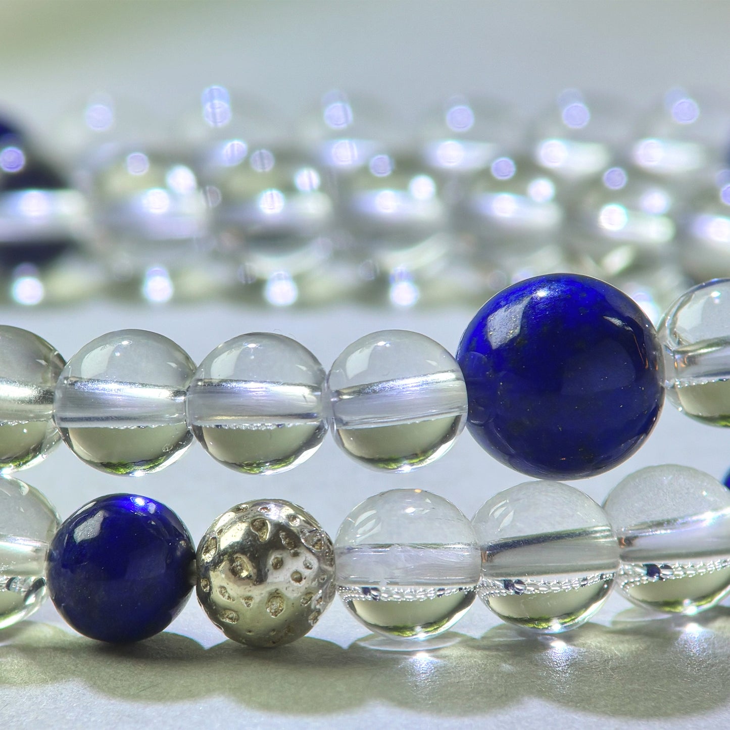 Close-up of Clear Quartz and Lapis Lazuli beads in a crystal bracelet for direct thinking