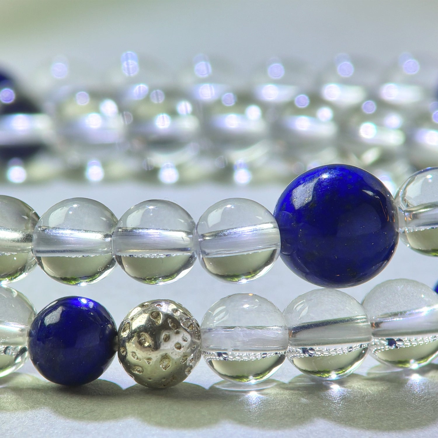 Close-up of Clear Quartz and Lapis Lazuli beads in a crystal bracelet for direct thinking