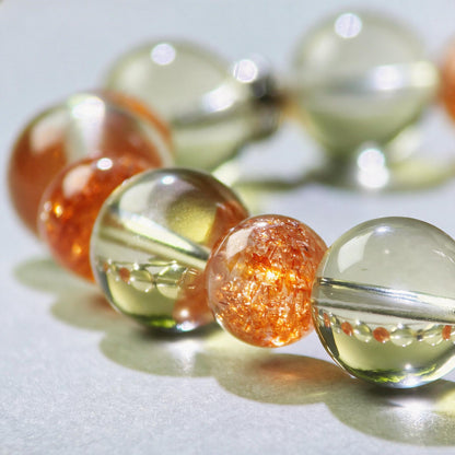 Close-up of Citrine and Golden Sunstone beads in a crystal bracelet for clearer decisions and earlier action
