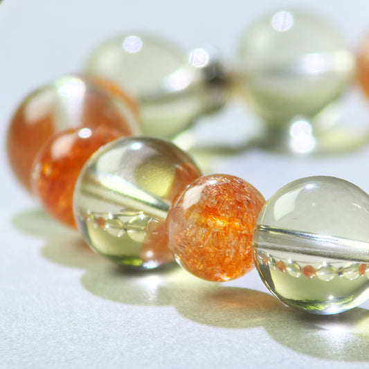 Close-up of Citrine and Golden Sunstone beads in a crystal bracelet for clearer decisions and earlier action