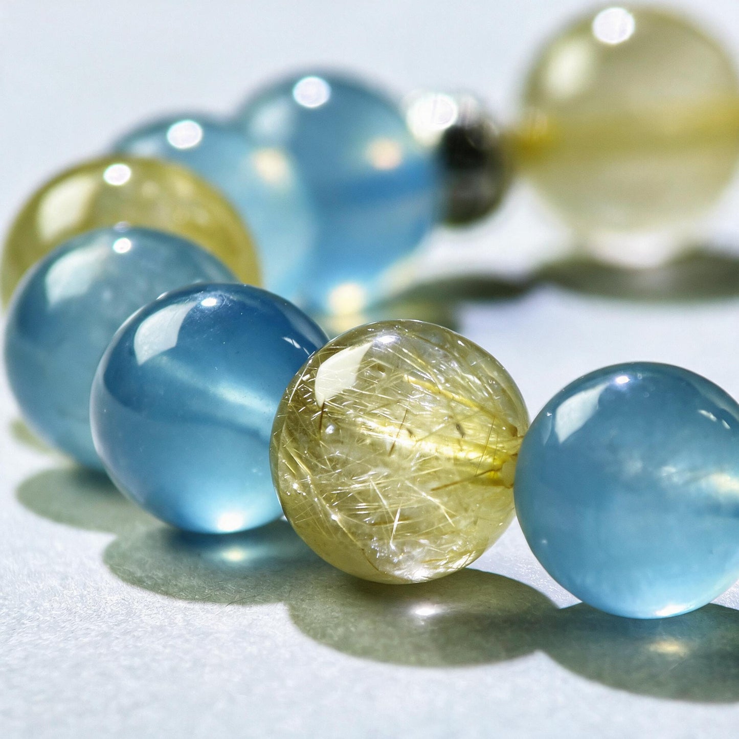 Close-up of Aquamarine and Golden Rutilated Quartz beads in a crystal bracelet for confident communication and stronger presence
