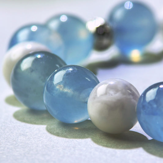 Close-up of Aquamarine and White Phantom Quartz beads in a crystal bracelet for smoother expression and easier communication