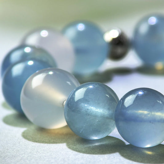Close-up of Aquamarine and White Agate beads in a crystal bracelet for steadier communication and clearer responses