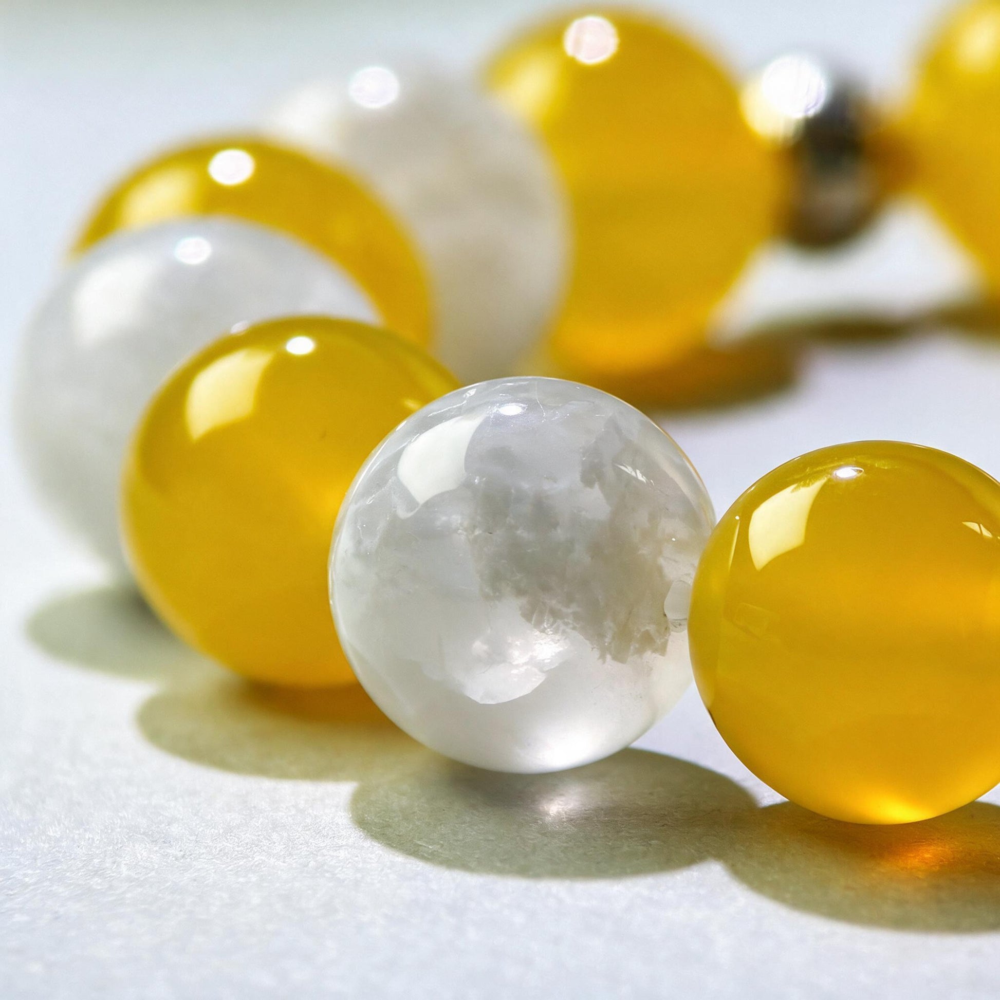 Close-up of Yellow Agate and White Phantom Quartz beads in a crystal bracelet for easing pressure