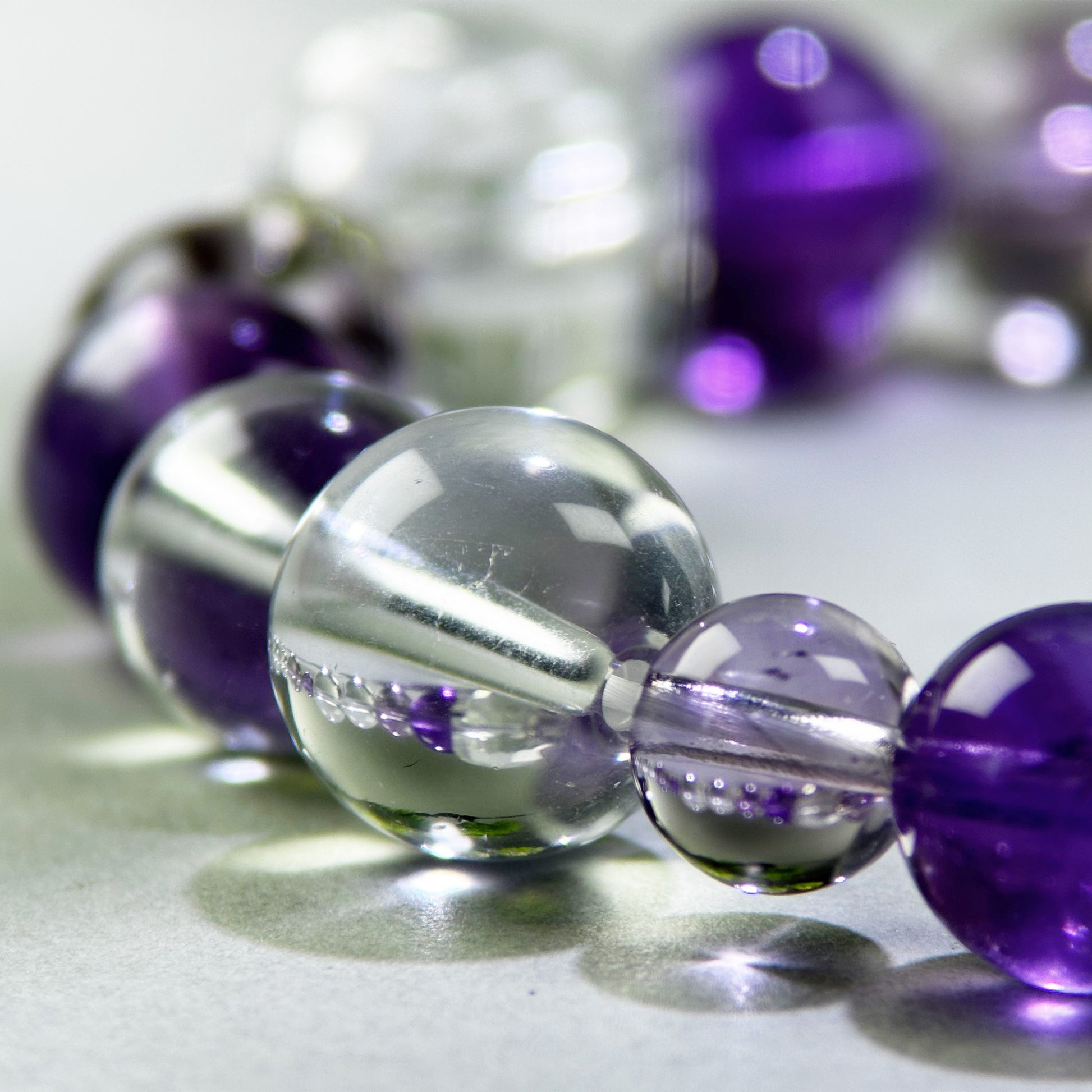 Close-up of Amethyst and Clear Quartz beads in a crystal bracelet for mental clarity and focused thinking