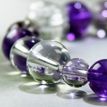 Close-up of Amethyst and Clear Quartz beads in a crystal bracelet for mental clarity and focused thinking