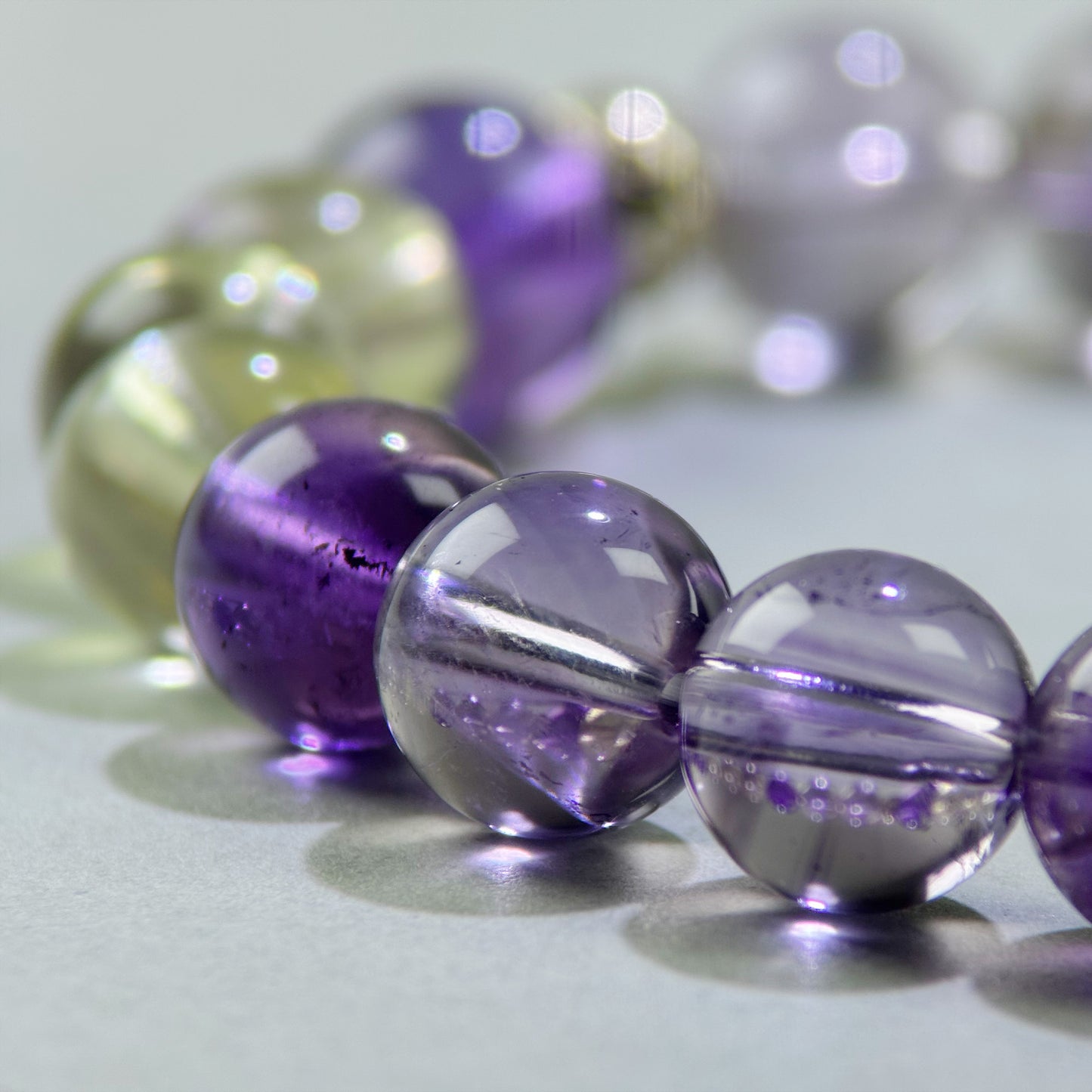Close-up of Amethyst and Citrine beads in a crystal bracelet for mental calm and greater self-trust
