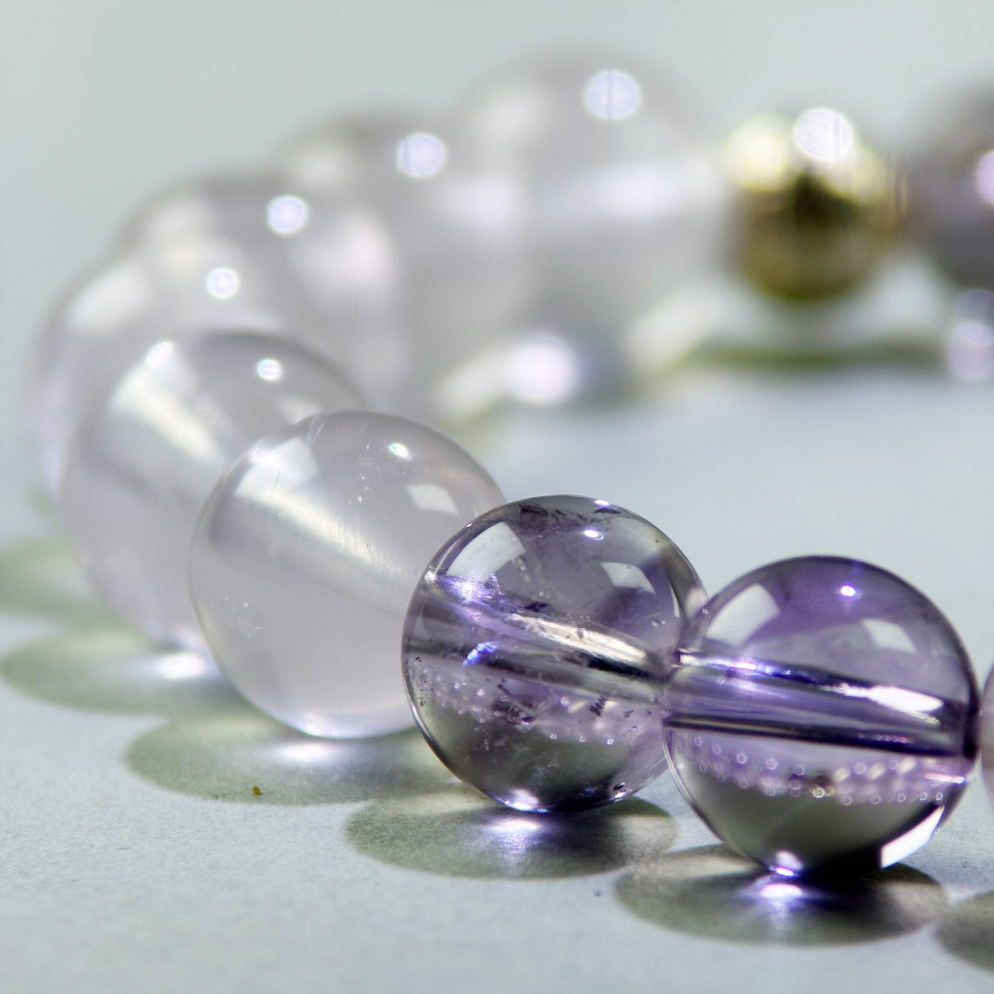 Close-up of Rose Quartz and Amethyst beads in a crystal bracelet for calm and emotional reconnection after conflict