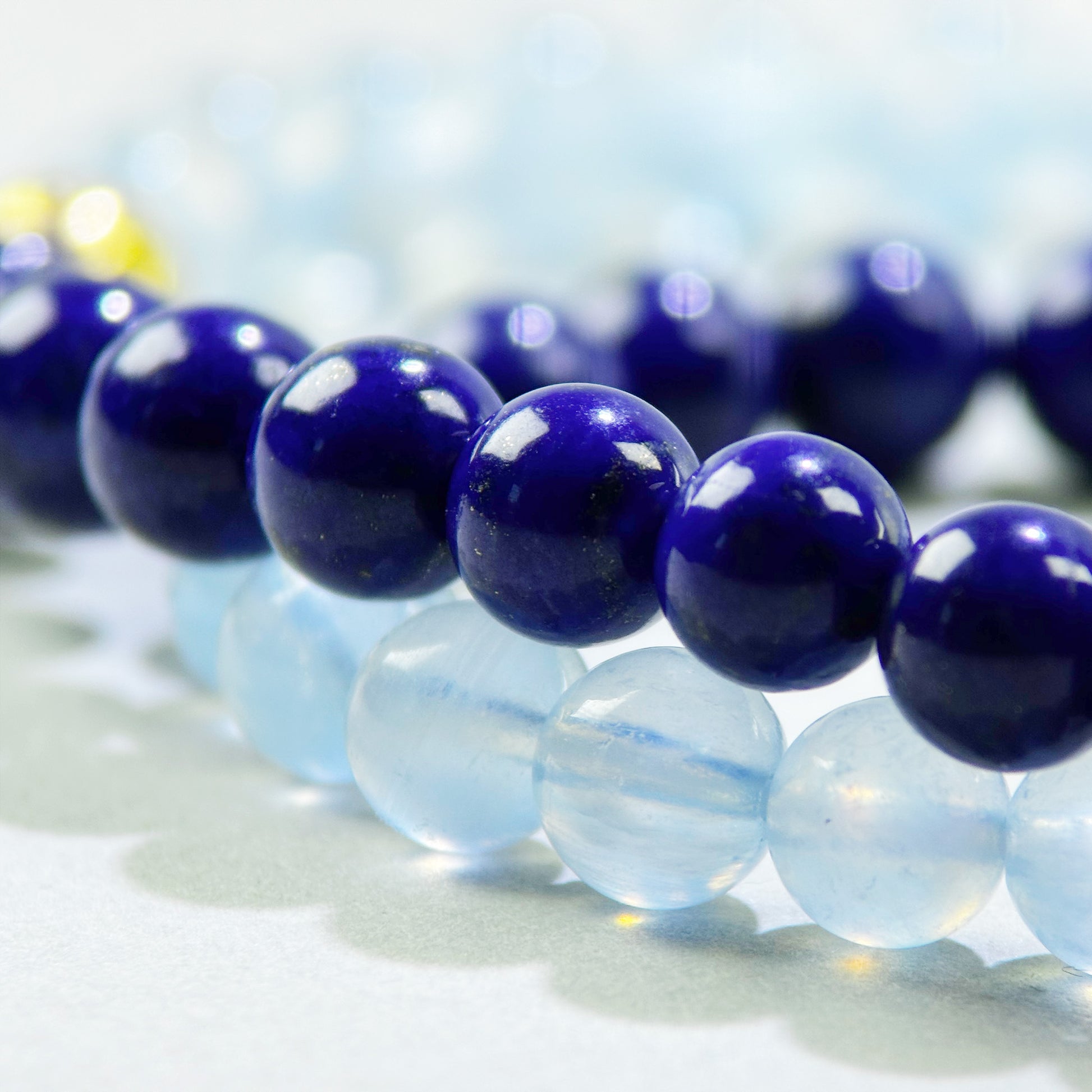 Close-up of Lapis Lazuli and Aquamarine beads in a crystal bracelet for structured thinking and clear communication