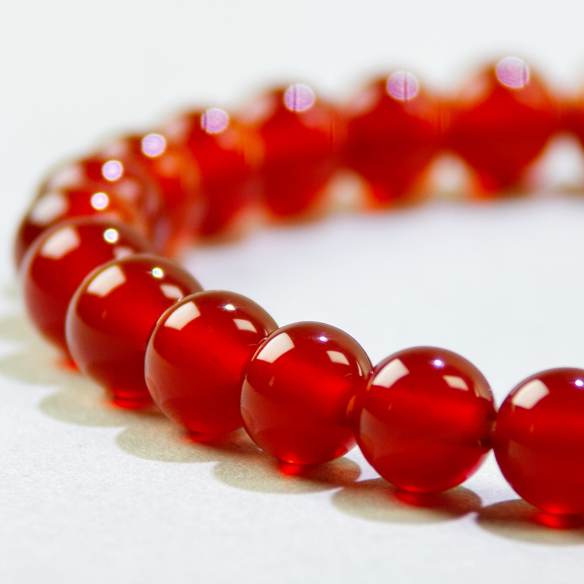 Close-up of Carnelian beads in a crystal bracelet for activation, initiative, and forward movement