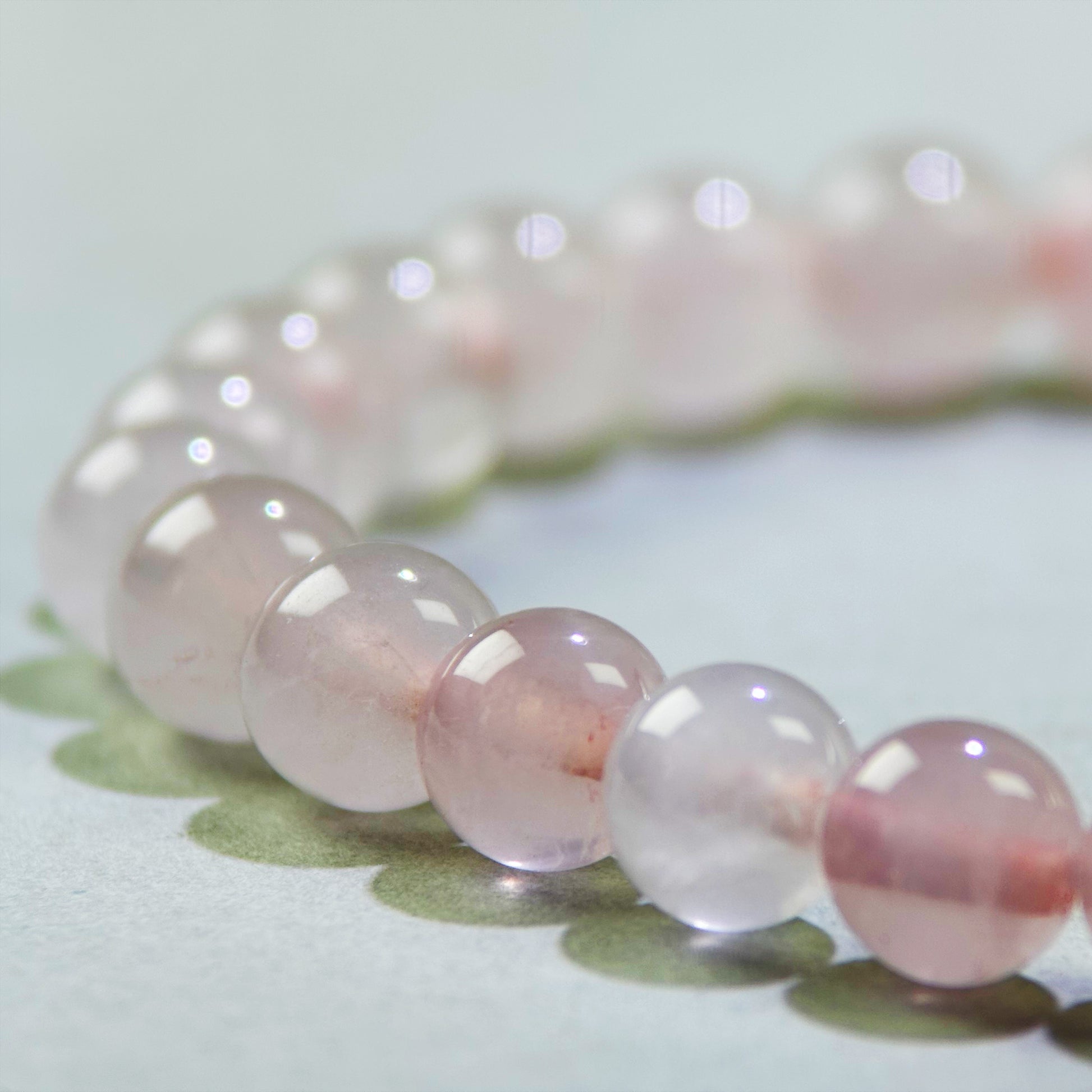 Close-up of Rose Quartz beads in a crystal bracelet for receiving love and feeling more open to connection