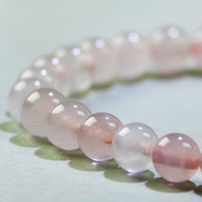 Close-up of Rose Quartz beads in a crystal bracelet for receiving love and feeling more open to connection