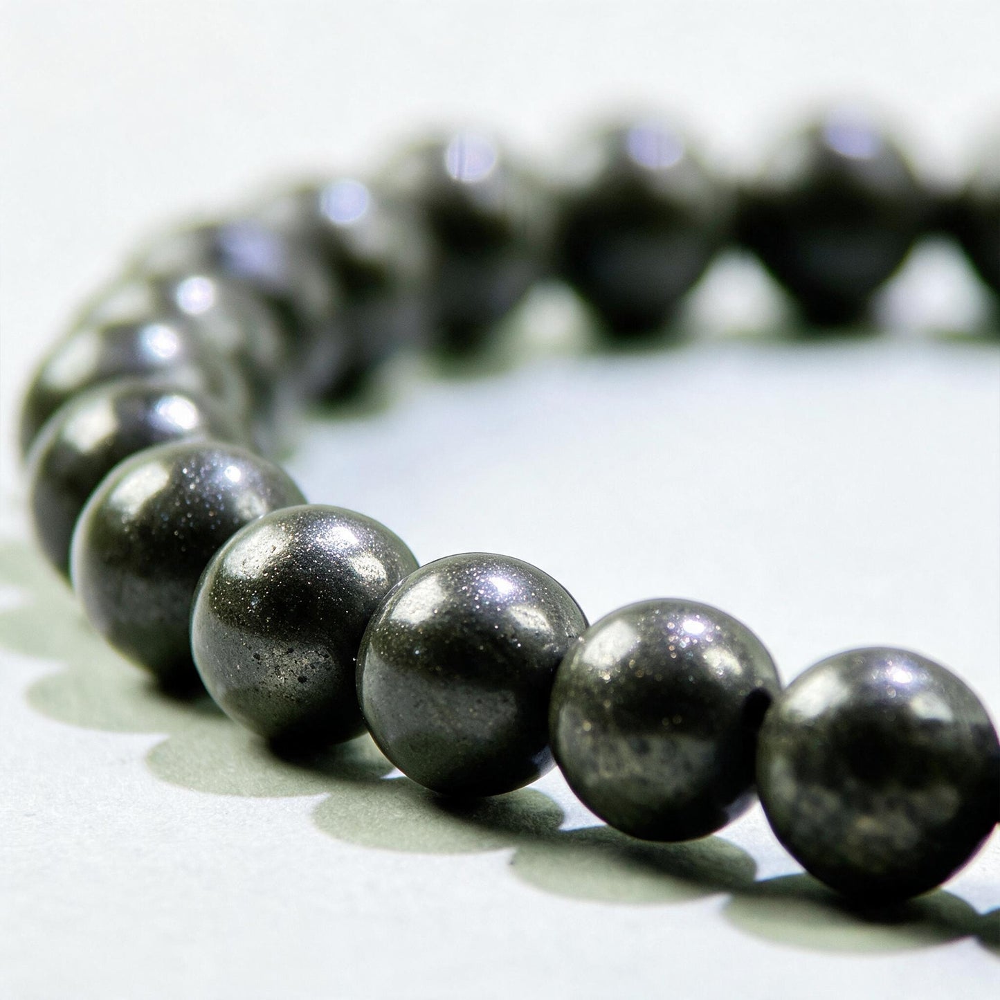 Close-up of Pyrite beads in a crystal bracelet for confidence around money, work, and financial opportunities