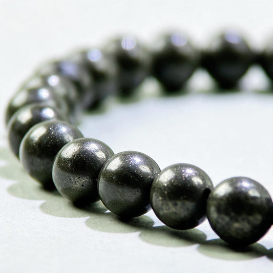 Close-up of Pyrite beads in a crystal bracelet for confidence around money, work, and financial opportunities