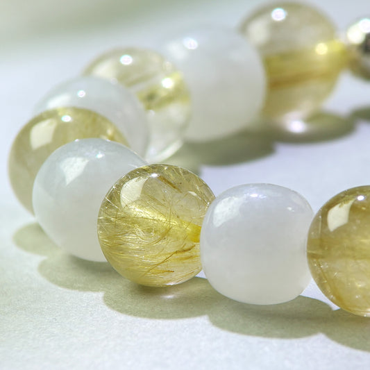 Close-up of Golden Rutilated Quartz and White Hetian Jade beads in a crystal bracelet for steadier responses and clearer internal boundaries