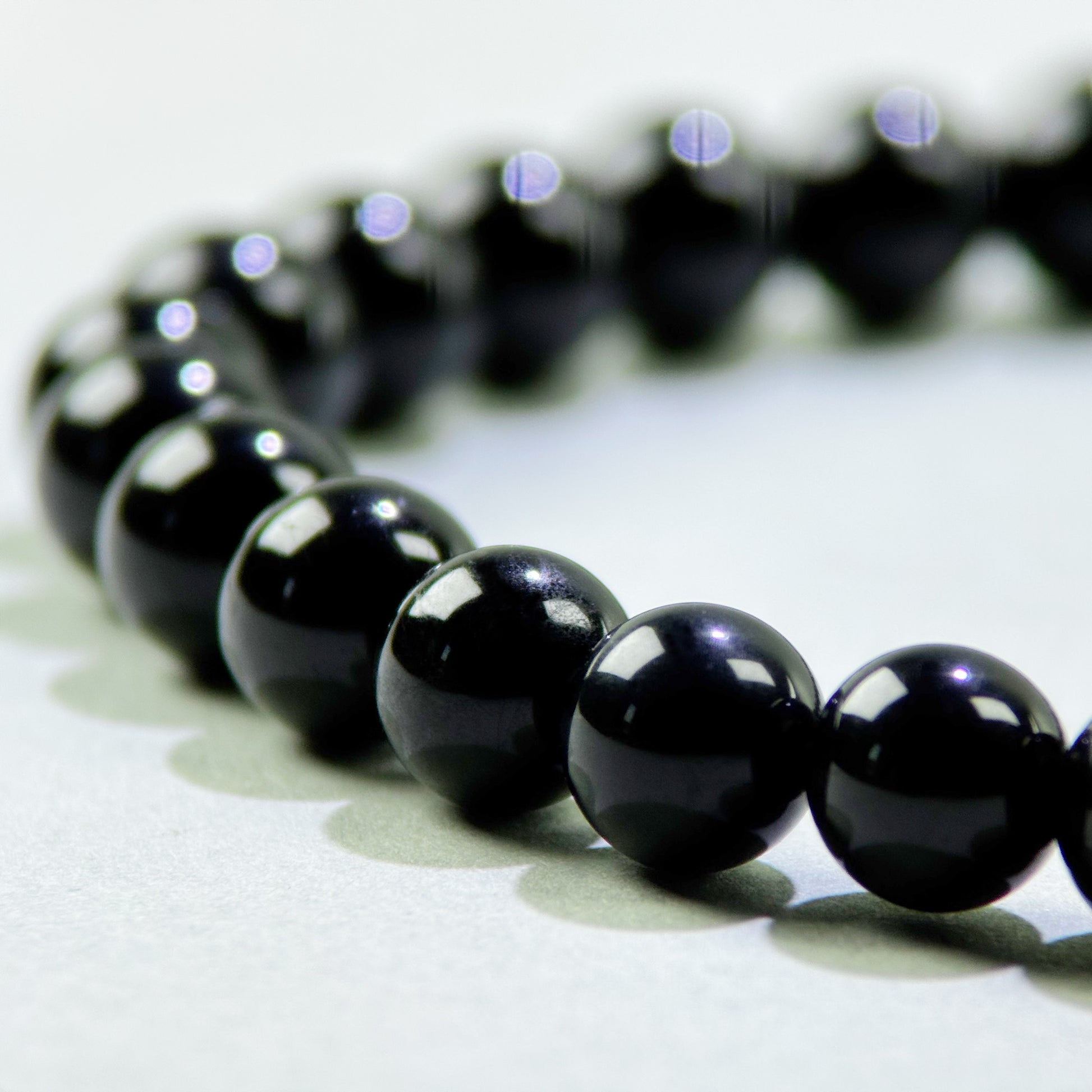 Close-up of Black Tourmaline beads in a crystal bracelet for protection from outside emotional pressure