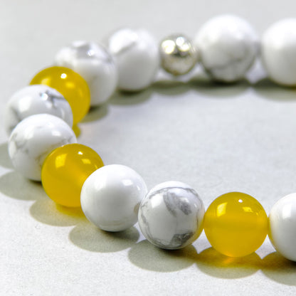 Close-up of Howlite and Yellow Agate beads in a crystal bracelet for patience and a slower internal pace