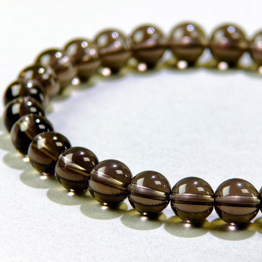Close-up of Smoky Quartz beads in a crystal bracelet for grounding, stability, and energy protection