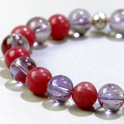 Close-up of Amethyst and Rhodonite beads in a crystal bracelet for quieter thoughts and emotional healing