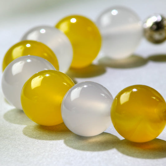 Close-up of Yellow Agate and White Agate beads in a crystal bracelet for mental slowing and a clearer sense of completion