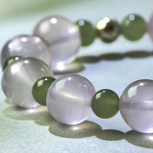 Close-up of Rose Quartz and Green Hetian Jade beads in a crystal bracelet for emotional connection