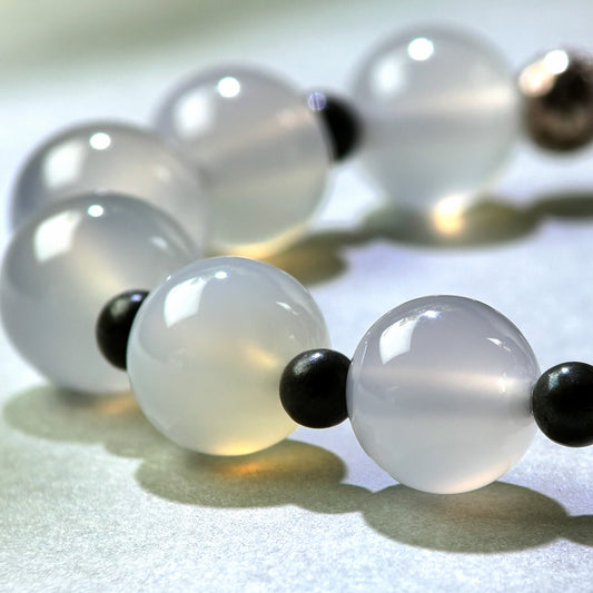 Close-up of White Agate and Pyrite beads in a crystal bracelet for reducing quick reactions