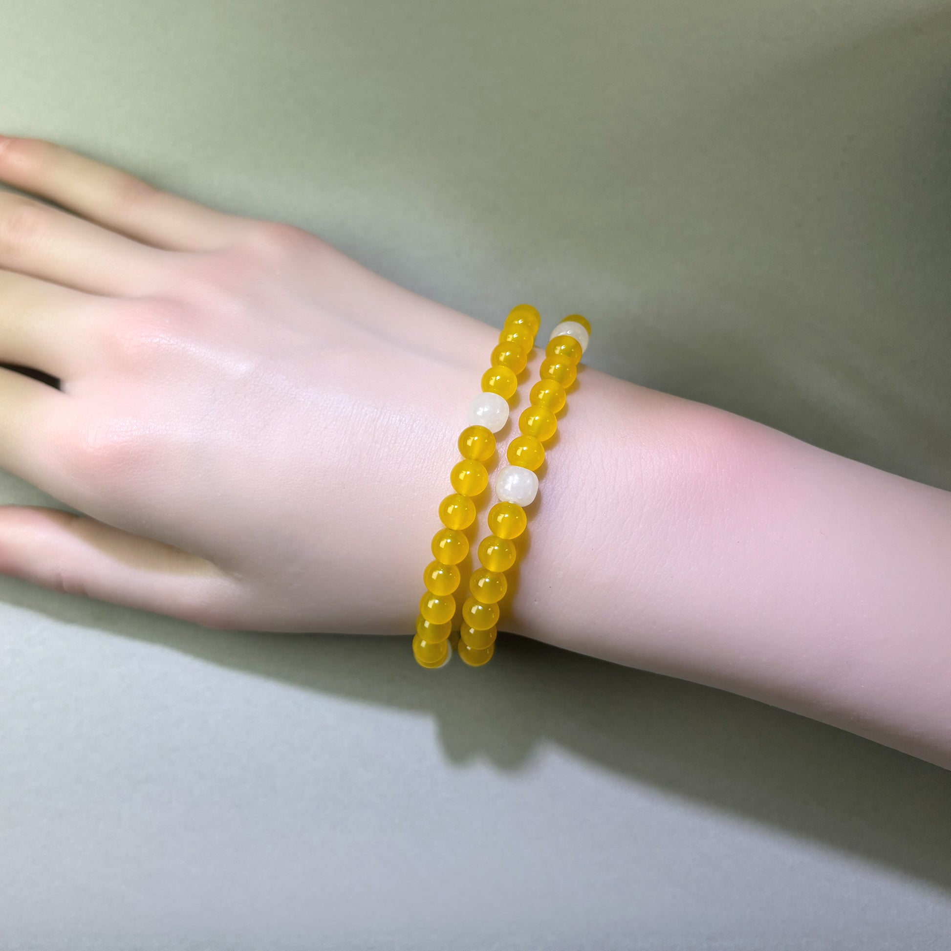 Yellow Agate and White Hetian Jade bracelet worn on wrist for helping the mind settle instead of carrying things forward