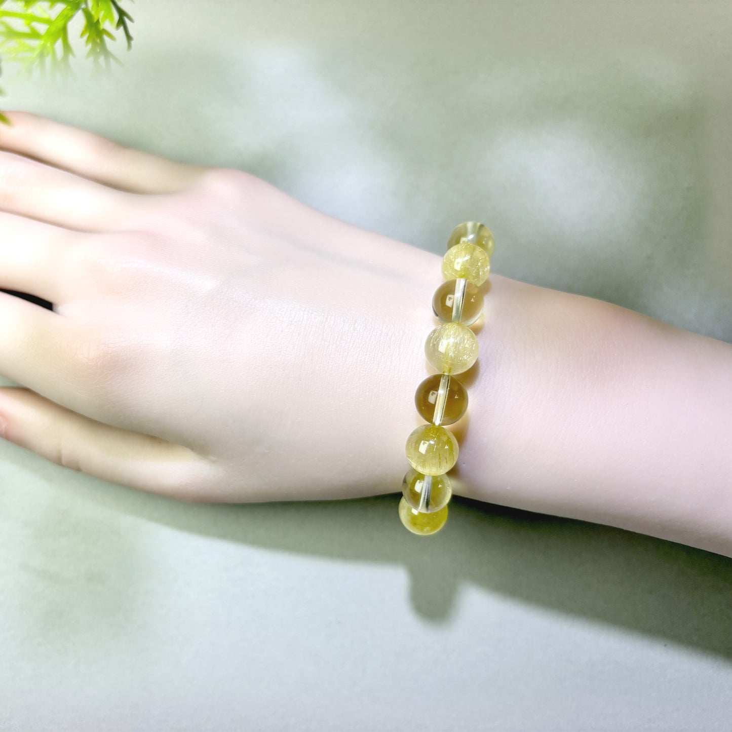 Golden Rutilated Quartz and Citrine bracelet worn on wrist for turning effort into real progress