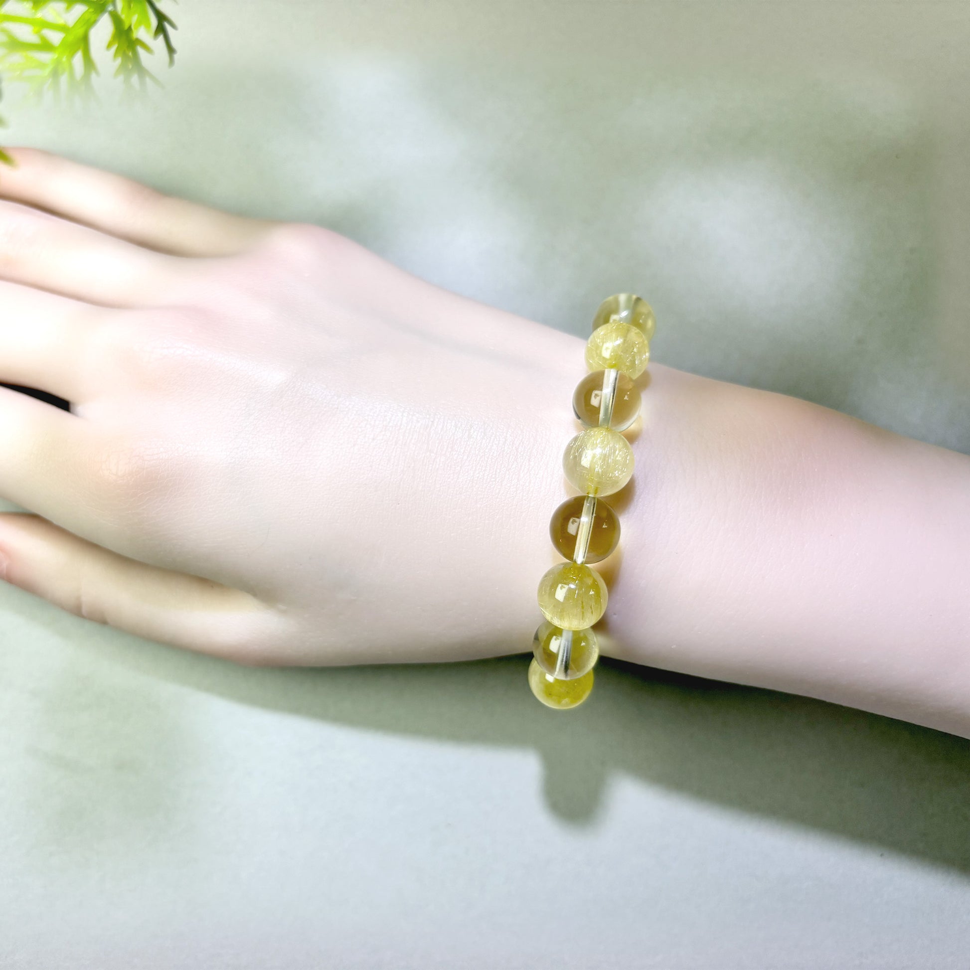 Golden Rutilated Quartz and Citrine bracelet worn on wrist for turning effort into real progress
