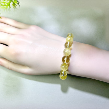Golden Rutilated Quartz and Citrine bracelet worn on wrist for turning effort into real progress