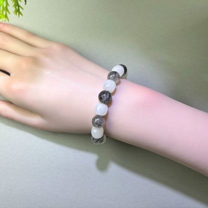 White Hetian Jade and Black Rutilated Quartz bracelet worn on wrist for steadier inner stability and less emotional carry-over